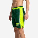 Opposite side view of custom sublimated green basketball shorts with neon yellow panel and split hem detail at the knee