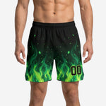Side view of custom green and black basketball shorts showing flame pattern coverage from hem to mid-section with elastic waistband and internal drawcord