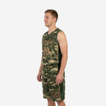 Side view of custom green basketball uniform showing solid dark green side panel stripe on shorts and bound armhole on sleeveless jersey