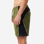 Custom green and black soccer shorts full view showing sublimated color-block design for club and team orders