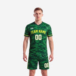 Custom green camo soccer uniforms front view showing forest camo jersey with neon yellow team name and number with matching shorts