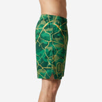 Side view of custom green and gold camo basketball shorts showing elastic waistband, side split at hem, and full-panel sublimated print