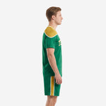 Side view of sublimated kelly green and gold soccer kit with matching shorts and gold side stripe