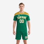 Custom green and gold soccer uniform kit with athletic gold shoulder yoke and white trim, front view