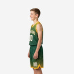 Side view of green youth basketball uniform set showing halftone dot fade pattern on jersey and shorts with gold hem stripe