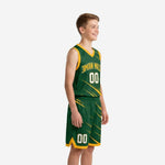 Side view of green and gold youth basketball uniform set showing slash streak pattern continuing across jersey and shorts