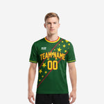 Custom green soccer jersey in Forest Green with Athletic Gold star print and Crimson diagonal stripes, front view on adult male model