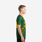 Custom green soccer jersey showing Athletic Gold sleeve cuff trim and star-field sublimation print, left side view