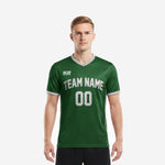 Front view of a custom green soccer jersey team kit in Forest Green with white arched team name and front number, worn by a male model