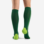 Custom green soccer socks in Forest Green with Neon Yellow heel and toe panels, back view showing contrast calf stripe
