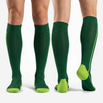 Custom green soccer socks in Forest Green and Neon Yellow shown from four angles including front, back, and side views