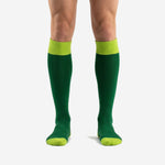 Custom green soccer socks in Forest Green with Lime Green ribbed cuff, heel, and toe panels, front view on male model