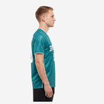 Left side view of custom green soccer team jersey in Teal showing short sleeve cuff trim and tonal geometric pattern