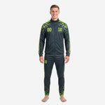 Custom green soccer tracksuit 2-piece set in graphite and neon green worn by adult male model, front view showing chest number and team logo print zones