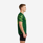 Green soccer training jersey side view showing Neon Green camo sleeve pattern and athletic cut on male model