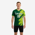 Custom green soccer training jersey in Forest Green and Lime Green with diagonal brush-stroke graphic, team name and number on chest, worn by adult male model, front view