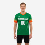 Custom green soccer training jersey with orange gradient sleeves and white team name and number on chest, front view on male model