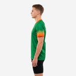 Custom green soccer training jersey with orange V-neck collar and gradient sleeve cuffs, right side profile view on male model