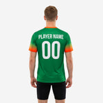 Close-up side view of custom green soccer training jersey showing Kelly Green to orange gradient fade across short sleeve cuff