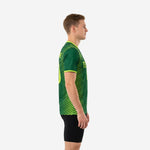 Custom green soccer training jersey side view showing neon green diagonal stripe pattern extending across sleeve and lower panel, athletic fit on adult male model