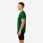 Custom green soccer training jersey right side view showing full Forest Green back panel and Lime Green sleeve cuff detail, adult male model