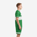 Custom green soccer uniform Kelly Green two-piece kit with white hex trim, left side view on adult male model