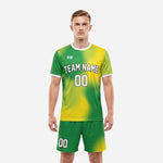 Custom green soccer uniforms in Kelly Green and Yellow gradient, front view on male model showing team name and number on chest