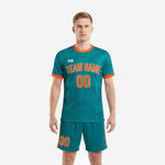 Custom green soccer uniforms in teal with orange ringer trim, full kit front view on male model