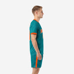 Custom green soccer uniforms teal and orange full squad kit side profile showing sleeve cuff trim