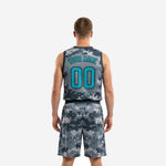 Back view of custom grey basketball uniforms showing player name and number in teal on digital camo jersey and matching shorts