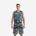 Custom grey basketball uniforms in digital camo pattern with teal team name and number on the front, matching shorts, full set front view