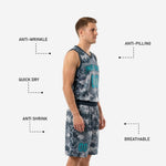 Close detail of grey digital camo basketball shorts showing teal number on left leg panel and elastic waistband with drawcord