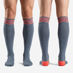 Full length pair of custom grey and coral knee high soccer socks for team orders