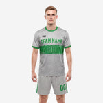 Custom gray soccer uniforms with Kelly Green speckle print jersey and matching grey shorts, front view on male model
