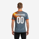 Back view of custom grey soccer training jersey with orange accent trim and sublimated spark graphic across upper back