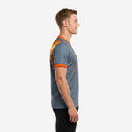 Grey soccer training jersey with orange sleeve cuff trim and sublimated graphic, left side view on male model