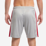 Grey soccer shorts elastic waistband with red drawcord detail, close-up view
