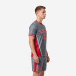 Side view of custom grey and red soccer outfit showing curved red panel insert and white piping detail