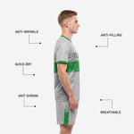 Custom grey soccer shorts with Kelly Green outer-leg stripe and player number, part of full uniform set