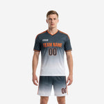 Custom grey soccer uniform with Charcoal-to-White gradient jersey and matching shorts, Orange trim, front view on adult male model