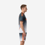 Custom grey soccer uniform Charcoal-to-White gradient side view showing Orange shoulder stripes and matching shorts on adult male model