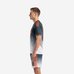 Grey soccer uniform kit side profile view showing full Charcoal gradient fade to White with Orange side stripe trim on jersey and shorts