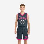 Custom grey youth basketball uniforms in charcoal and hot pink showing front and back of the full jersey and shorts set