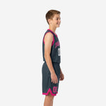 Front view of custom grey youth basketball uniforms with arched team name in pink and white number on charcoal jersey