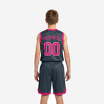 Opposite side view of grey and pink youth basketball jersey and shorts showing clean hem split and elastic waistband