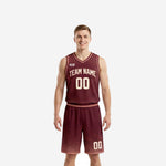 Custom high school basketball uniforms in maroon and blush pink with sunburst jersey pattern and diamond fade shorts front view
