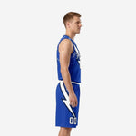 Royal blue custom high school basketball uniforms front view showing team name arc, front number, and diagonal lightning bolt on jersey and shorts