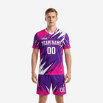 Custom hot pink soccer uniforms with royal purple geometric burst print, front view showing team name and number on jersey and matching shorts