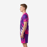 Custom pink soccer uniform side view right displaying hot pink and royal purple angular burst design on jersey and shorts