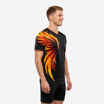 Custom soccer training shirt in Jet Black and Neon Orange flame graphic, right side angle on male model